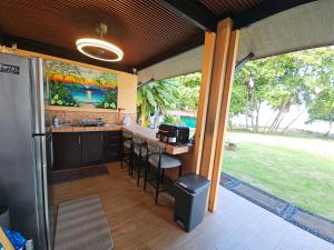 an outdoor kitchen with a counter and a table at Outback Hermosa in Playa Hermosa