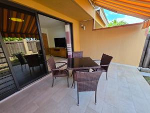 a patio with a table and chairs and a television at Feri Lodge in Tohautu