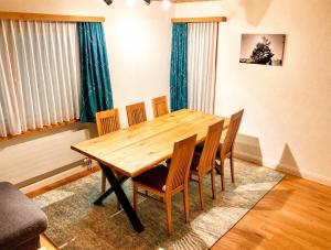a wooden table and chairs in a room at Chasa ARLU in Samnaun
