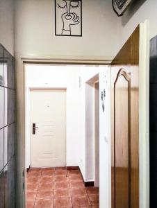 a hallway with a white door and a tile floor at Apartment Bay View in Kotor +28 photos