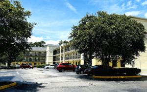 a parking lot with cars parked in front of a building at Studio Lodge of Augusta in Augusta
