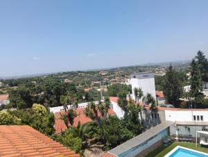 a view of the city from the roof of a building at Vila les Roses Quartos Jardim e Montanha in Porches
