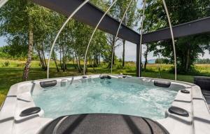 a hot tub with chairs around it in a yard at Country house Greenfields in Gospić