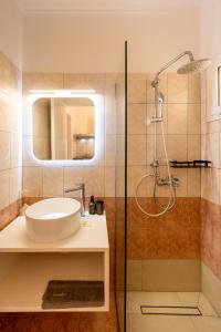 a bathroom with a sink and a shower at Garden Studios in Alykes +68 photos