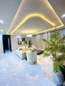 a living room with couches and a plant at Luxurious Altitude in Lekki