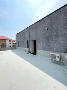 a large brick building with a large open door at Luxurious Altitude in Lekki