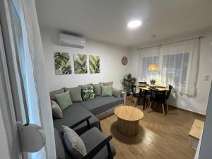 a living room with a couch and a table at Abigails Pool House in Kallirákhi