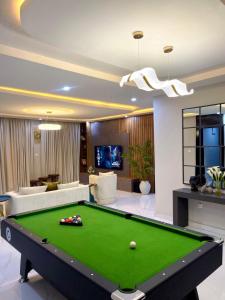 a living room with a pool table at Luxurious Altitude in Lekki