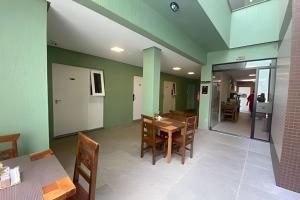 a dining room with a table and chairs at Pousada Beach in Capão da Canoa