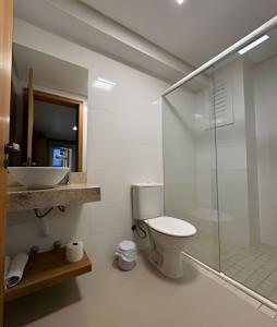 a bathroom with a toilet and a glass shower at Pousada Beach in Capão da Canoa +68 photos