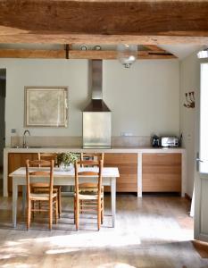 a kitchen with a table and chairs and a stove at Château de Chavigny in Chambourg-sur-Indre