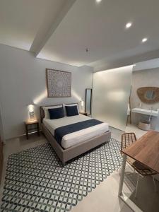 a bedroom with a king sized bed and a table at Borgo Bianco in Vieste