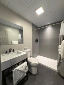 a bathroom with a sink and a toilet and a tub at Manistique Sands in Manistique +34 photos
