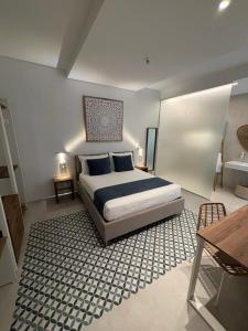 a bedroom with a king sized bed and a rug at Borgo Bianco in Vieste