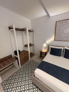 a bedroom with a bed with blue pillows at Borgo Bianco in Vieste +34 photos