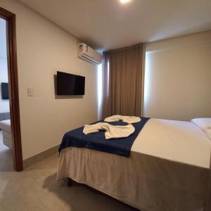 a hotel room with a bed with a towel on it at Freitas Residence - Quinta Manuel Rodrigues in Recife +60 photos