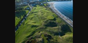 an aerial view of the shoreline of a beach at Harbour View House in Ballycastle