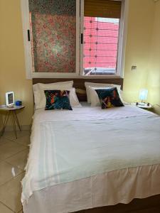 a bedroom with a large bed with a window at saidia 700 m de la plage in Saïdia