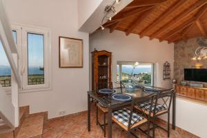 a dining room with a table and chairs and a window at Skatza Ocean Crest in Kamária