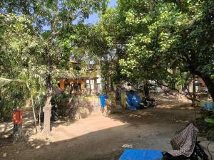 a yard with a fence and trees and a house at The Culture House in Mumbai