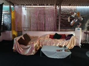 a bedroom with a large bed and a table at The Culture House in Mumbai