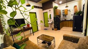 a living room with a couch and some plants at The Culture House in Mumbai