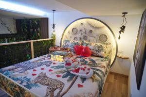 a bedroom with a bed with a table on it at Moonlight Jungle Suit Luxury experience in Avola