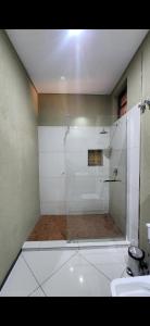 a shower with a glass door in a bathroom at ORO - Boutique Guesthouse in Matola