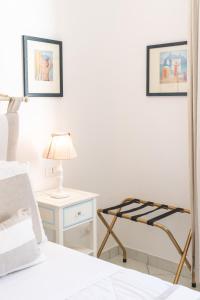 a bedroom with a bed and a table and a lamp at Queen Suite - Luxury Rooms in Forio d'Ischia