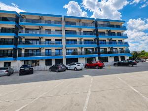 an apartment building with cars parked in a parking lot at Studio ANA Saturn 1 in Saturn