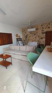 a living room with a white couch and green chairs at Precioso chalet en Telchac Puerto in Telchac Puerto +13 photos