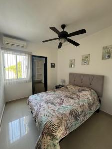 a bedroom with a bed and a ceiling fan at Casa Flamingo in Bucerías +43 photos