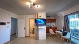 a kitchen with a refrigerator and a table with chairs at Escobar Apart CENTRO in Belén de Escobar