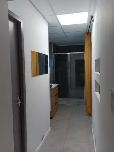 a room with a hallway with a sink and a bathroom at Chambre indépendante in Le Vigan