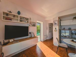 a living room with a flat screen tv on a wall at La La Land in Letojanni