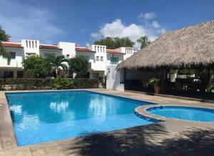 a swimming pool in front of a house at Casa Flamingo in Bucerías