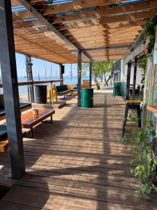 a wooden deck with benches on a building at Highway to Hel in Jastarnia