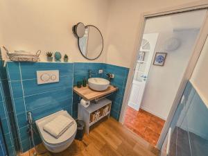 a bathroom with a toilet and a sink and a mirror at La La Land in Letojanni +15 photos