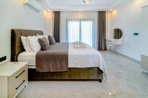 a bedroom with a large bed and a television at Olive villas in Fethiye +10 photos