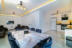 a living room with a table and a kitchen at Olive villas in Fethiye
