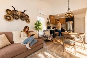 a woman sitting on a couch in a living room at Condo and Spa - Le Saloon Nordik in Saint Come +46 photos