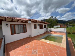 a house with a swimming pool in front of it at Casa Silvestre in Villa de Leyva