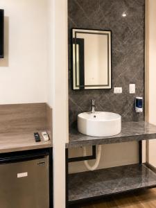 a bathroom with a sink and a mirror at Barrio Inn Morelos in Monterrey +18 photos