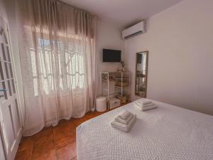 a bedroom with a bed with two towels on it at La La Land in Letojanni