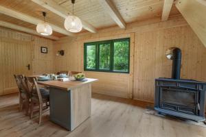 a kitchen with a stove and a table in a room at Mountain Retreat Stars Peak in Bačić Duliba +21 photos