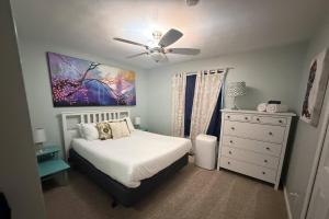 a bedroom with a bed and a ceiling fan at Glen Eagle Kingfisher Suite in Colorado Springs