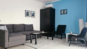 a living room with a couch and a table and chairs at Apartmani Tika in Golubac