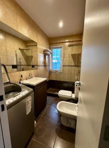 a bathroom with a sink and a toilet and a mirror at House51 "ubicado a solo 3 cuadras de la playa en pleno centro de Rada Tilly" in Rada Tilly