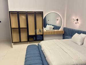 a bedroom with a large bed and a mirror at Pc Luxury 1 bedroom with pool in Lagos
