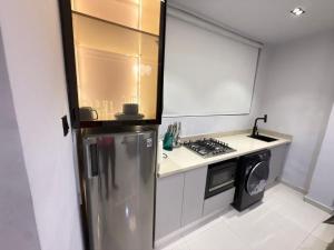 a kitchen with a stainless steel refrigerator and a stove at Pc Luxury 1 bedroom with pool in Lagos
